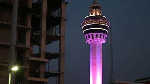 Illuminated Samut Prakan tower rises beside construction Video stock 339877349