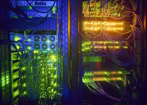 Illuminated servers and computer cables in server room Stock Photos