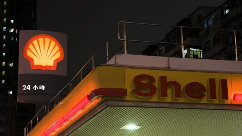Illuminated Shell Gas Station Logo, Sign &amp; Forecourt at Night in Hong Kong Stock Footage 307374987
