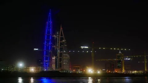 Illuminated skyscraper with blue lights reflected in water at night Stock-Footage 344996155