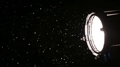 Illuminated snowflakes are seen in the light of a professional spotlight Stock-Footage 101023733