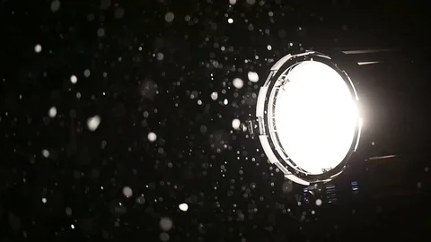 Illuminated snowflakes are seen in the light of a professional spotlight Video stock 101023743