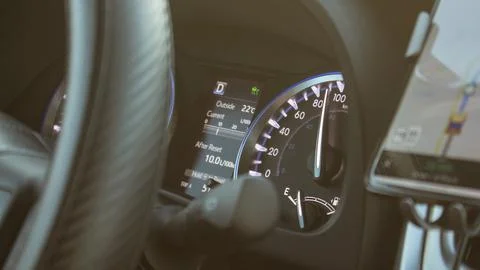Illuminated speedometer dashboard and steering wheel of a modern car in a s.. Stock Photos