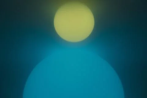 Illuminated spherical orbs, one large blue one and one small yellow one. Stock Illustration