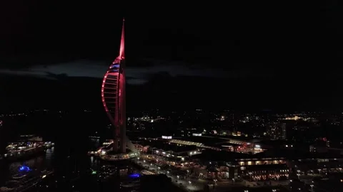 Illuminated Spinnaker tower pulsing red across Portsmouth harbour city skyline Stock Footage 332723190