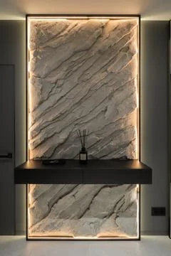 Illuminated stone wall panel and console table Stock Photos