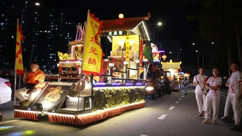 Illuminated Taoist Procession Float Traveling Through Urban Streets at Night Video stock 346245239
