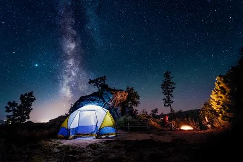 Illuminated tent under milky way at night, Caster National Park, South Dakota, Stock Photos
