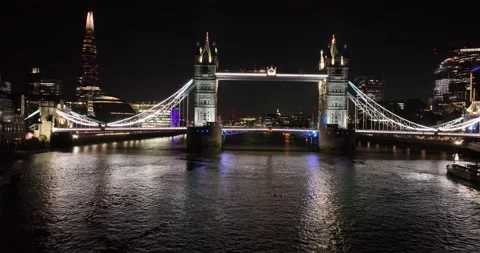 Illuminated Tower Bridge over Thames river at night Stock Footage 202292304