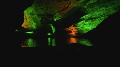 Illuminated underground cave with river reflection Stock Footage 340819296