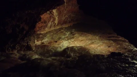 Illuminated Underground River in a Dark Red Cave Qızıl Qoba , Crimea , Russia Stock Footage 82299073