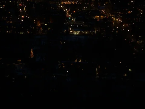 Illuminated village and mountains at night Stock Footage