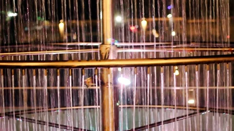 Illuminated water fountain structure creating mesmerizing vertical streams again Stock Footage 324978621