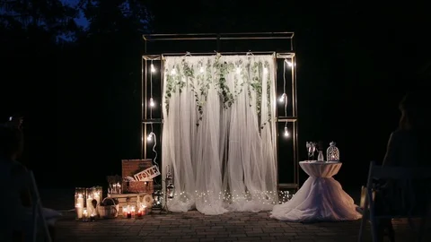 Illuminated wedding arch before the wedding night ceremony. Decoration for a Stock Footage 128244468
