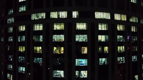 Illuminated windows of office building at winter evening. Aerial view Stock Footage 74458342