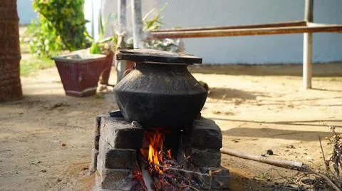 Illuminating fire in natural clay stove in rural village of Rajasthan India.  Stock Photos