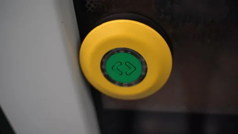 Illuminating push button on metro train doors, yellow and green button for Stock Footage 164249439