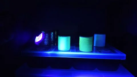 Illuminating the thread with a UV light Stock Photos