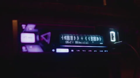 Illumination of car stereo during late night urban driving scene, Digital Stock Footage 327359609