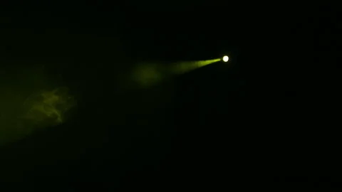 Illumination of the scene with a beam of yellow light from a spotlight in the Vídeo Stock 98826436