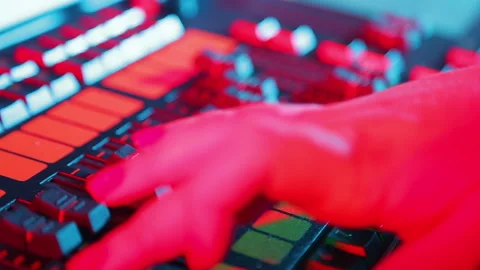 The illuminator's hand sets up the mixing light console and prescribes programs 库存影片 122638350