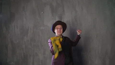 Illusionist is doing magic trick in slow motion. Magician man in black suit is Video stock 148755333