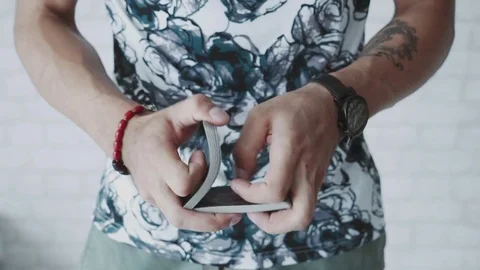 Illusionist hands showing tricks with playing cards Stock Footage 79767474