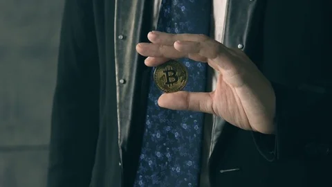 Illusionist performing trick with bitcoin Stock Footage 83855404