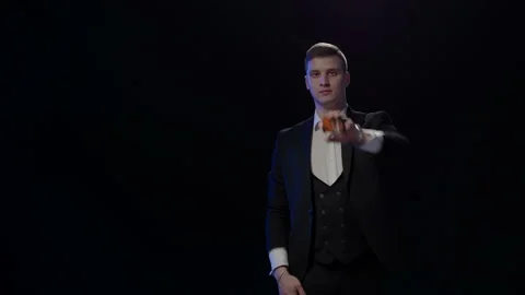 Illusionist showing trick with playing cards Stock Footage 129220258