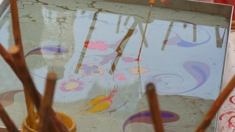 Illustrating trees and flowers using Oil on water art / Ebru / paper marbling Stock Footage 112005326