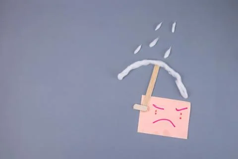 Illustration of a crying expression under an umbrella on a rainy day. Stock Photos