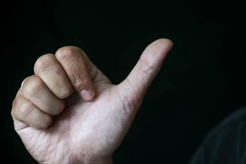 An illustration of a hand with thumbs raised to illustrate saluting someone. Stock Photos