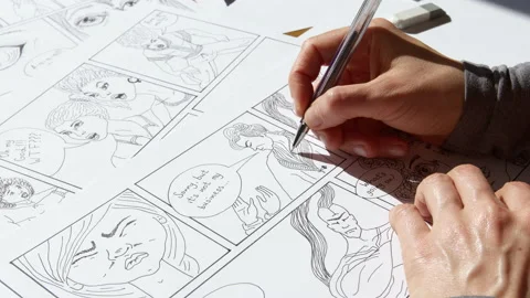 An illustrator artist draws a comic book storyboard on paper.  Stock Footage 181569108