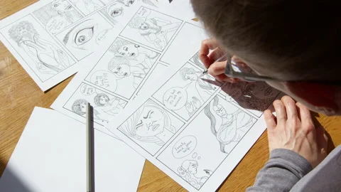 An illustrator artist draws a comic book storyboard on paper.  Stock Footage 181569220