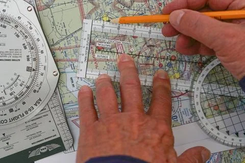 Ilot plots a flight on a sectional map for a vector from one airport to another. Fotos de archivo