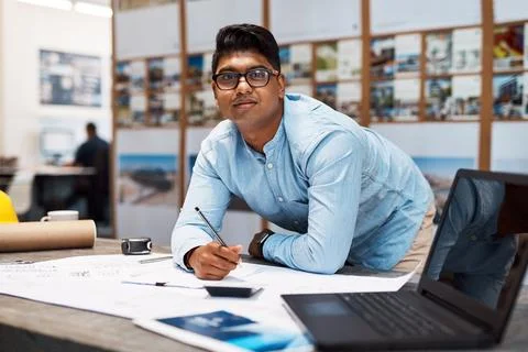 Im committed to completing this project. a young architect drawing up a building Fotos de archivo