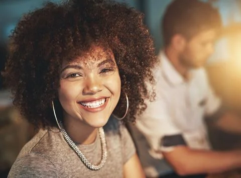 Im getting the job done quickly and calmly. a young designer working late with Stock Photos
