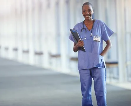 Im making a difference. a young nurse holding a patient file in the hospital 写真素材