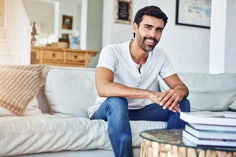 Im making relaxation a priority today. Portrait of a man relaxing on the sofa at Stock Photos