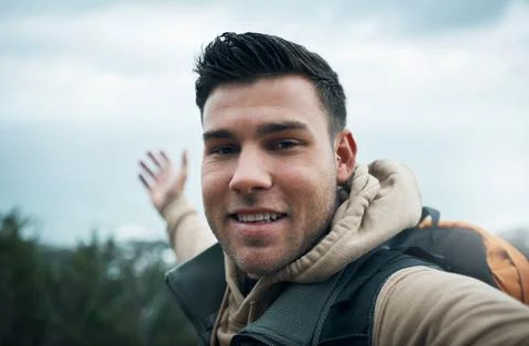 Im not lost, Im exploring. a young man taking selfies while out on a hike. Stock Photos