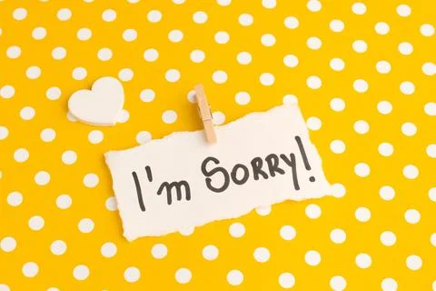 I'm sorry phrase write on a white paper on a yellow with white polka dots paper Stock Photos
