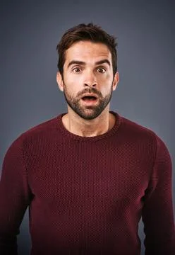 Im speechless. Studio shot of a handsome young man looking surprised against a Stock Photos