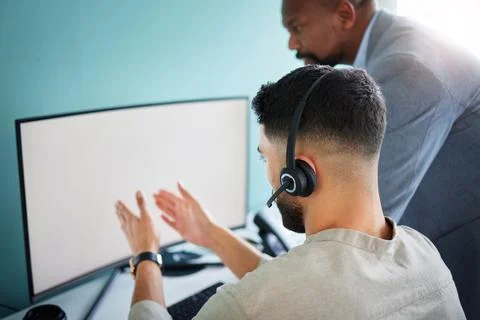 Im stuck on the same page. an unrecognisable call centre agent sitting and using Stock Photos
