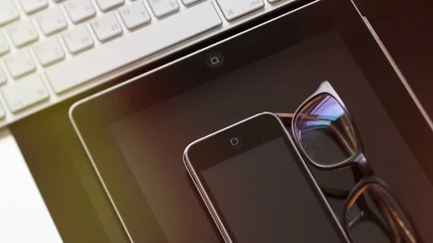IMac, iPad tablet, iPhone 3gs and eyewear lens flare Stock Footage 107783735