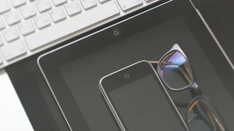 IMac, iPad tablet, iPhone 3gs and eyewear Stock Footage 107783739