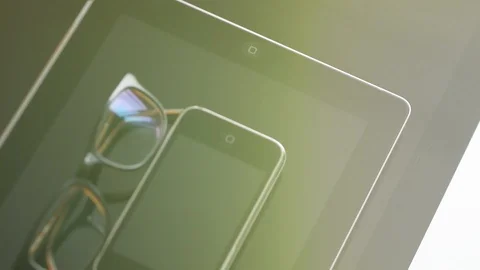IMac, iPad tablet, iPhone 3gs and eyewear green lens flare Stock Footage 107783773