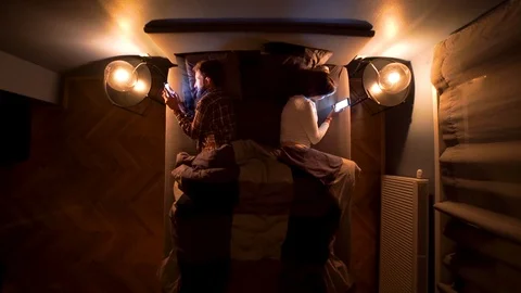 Image from above of couple addictive to the cell phone during the night. Stock Footage 119221361