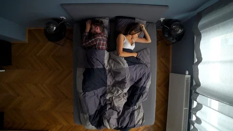 Image from above of couple sleeping together and man waking up early. Stock Footage 119221868