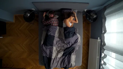 Image from above of couple sleeping together and woman waking up early. Stock Footage 119222482