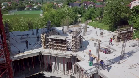 Image from above during the summer of a block of flats, you can see the workers Stock Footage 208027995